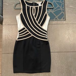 Mini dress with asymmetrical lines. black and beige color.